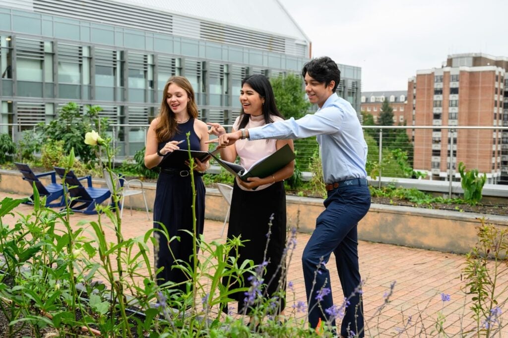 Group of Georgetown Students standing near a garden